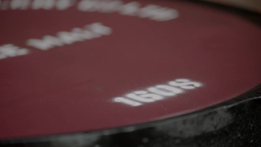 Water drips onto a red surface with white numbers