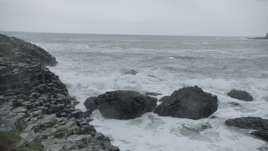 The basalt hillside of giants causeway along the sea