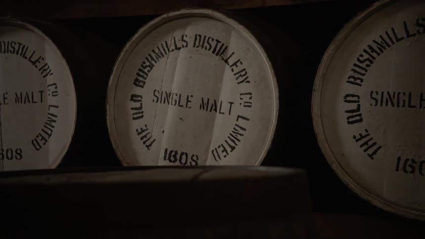 Barrels of liquor are laying beside each other