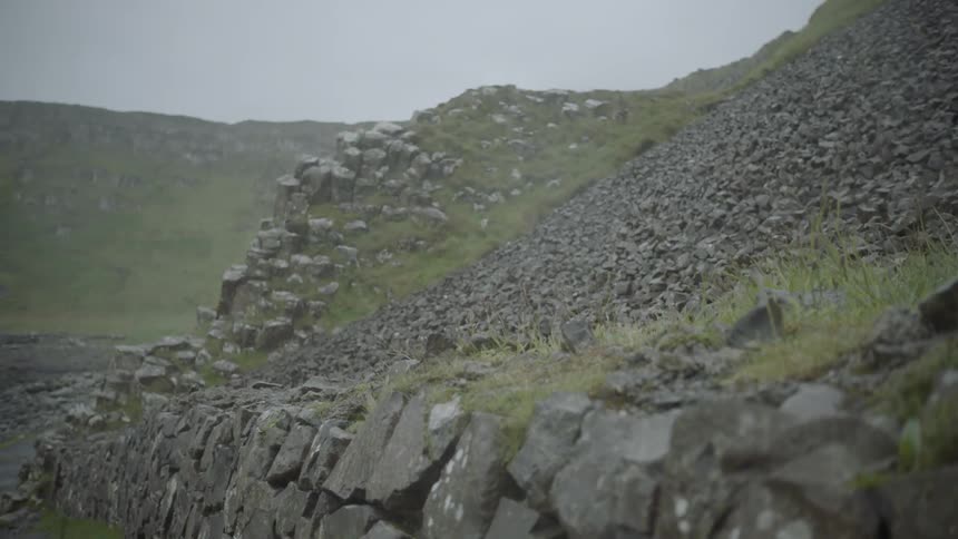 Camera moves upwards showing a rocky mountainside