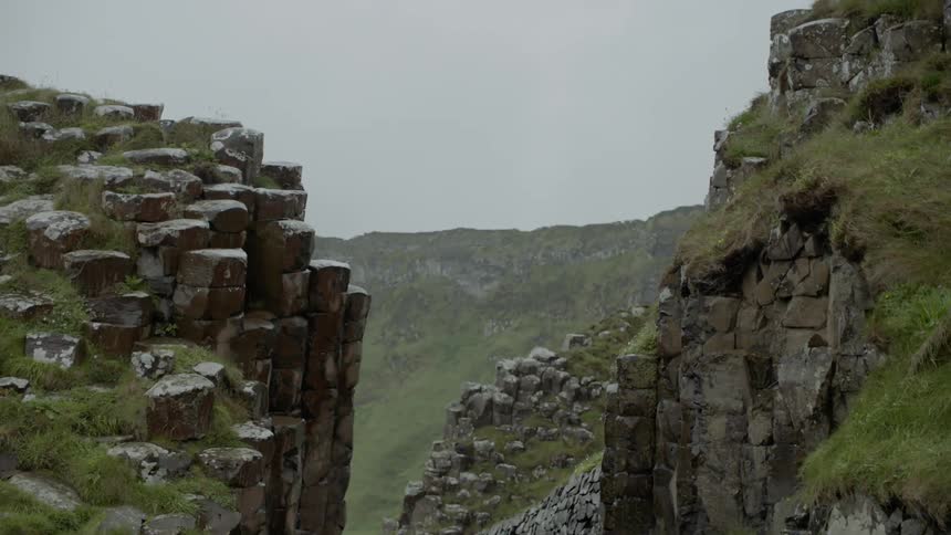 The mountains are covered with green on a foggy day