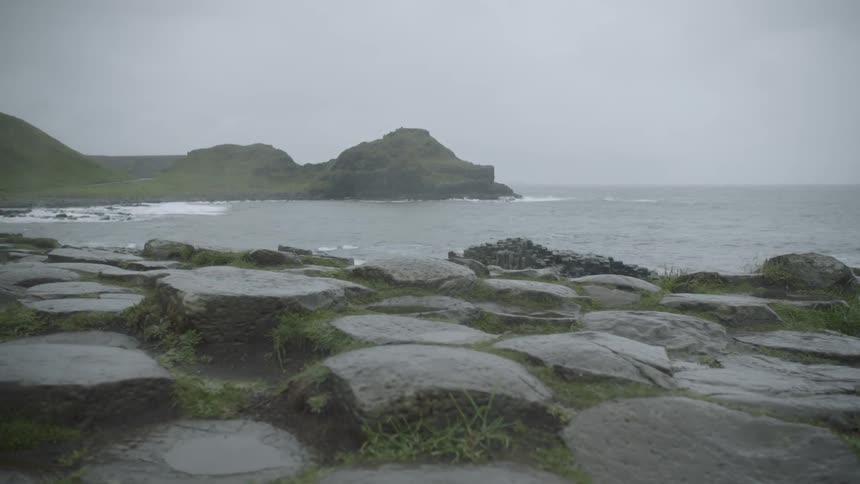 The rocky shore of a bay on a foggy day