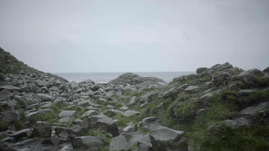 Slow camera pan revealing rocky coastline