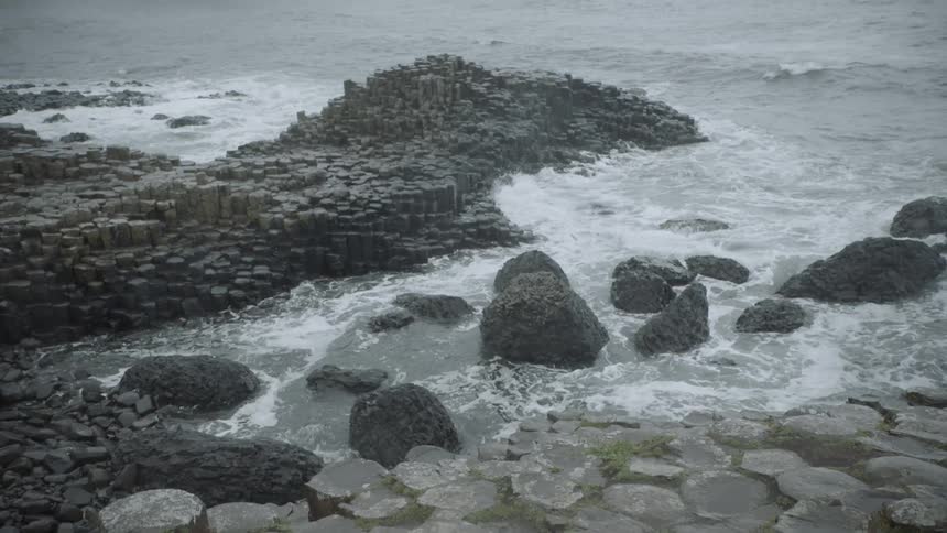 Looking at stones that are are the edge of a cliff in the ocean