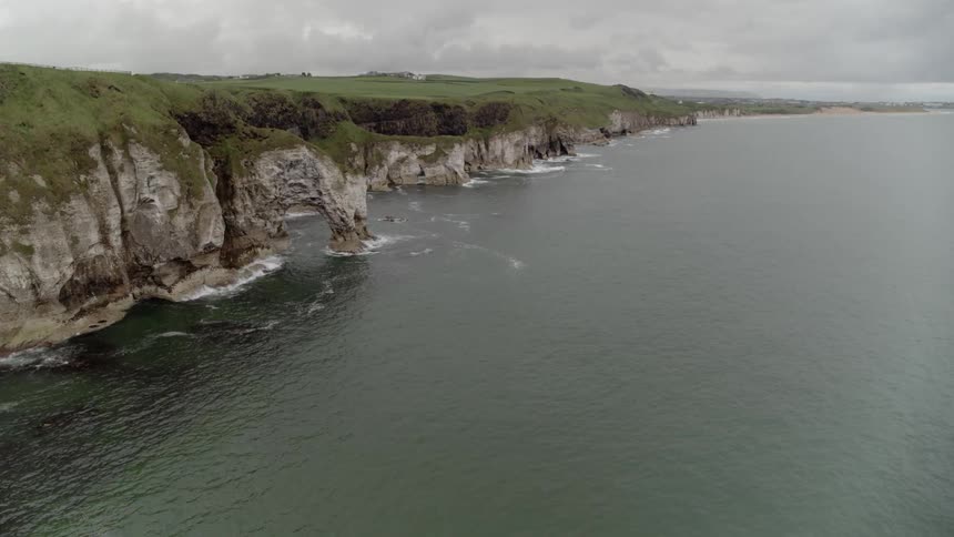 Wide aerial shot of ocean coastline