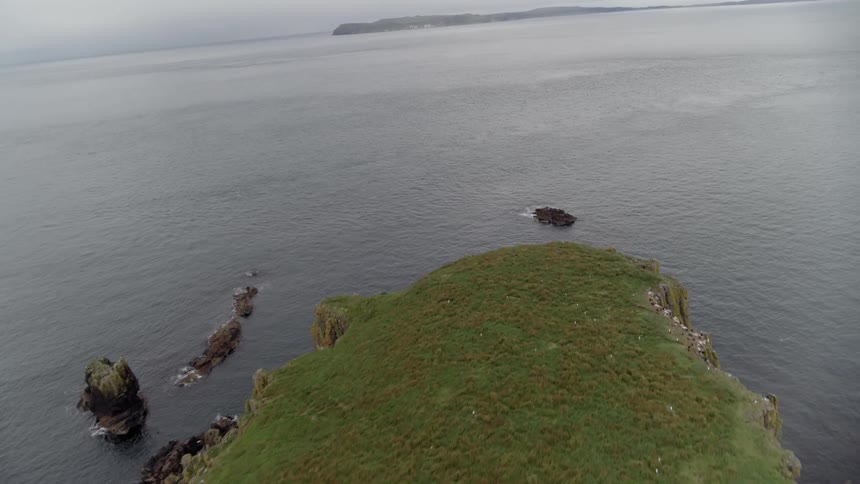 A large craggy island sits in the ocean