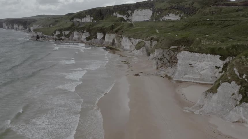 Waves are crashing along the coast of the beach