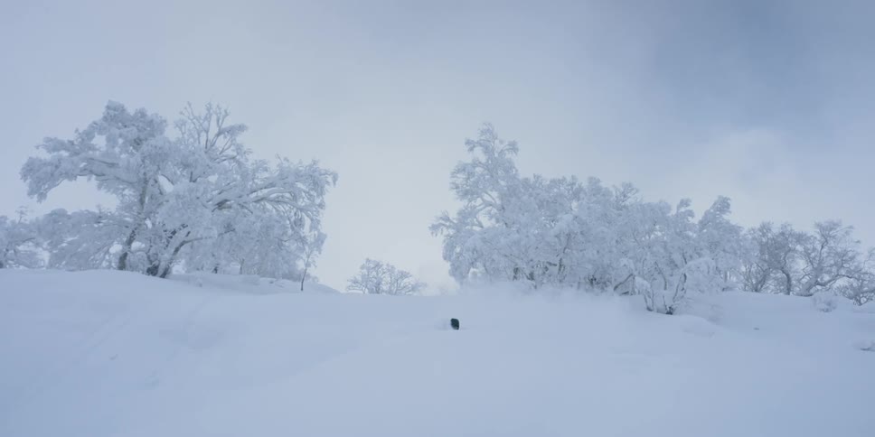 A person skiing down shallow snow covered slopes
