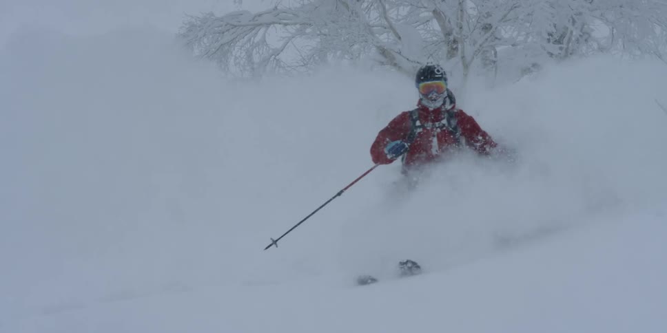 A person skis down the slope