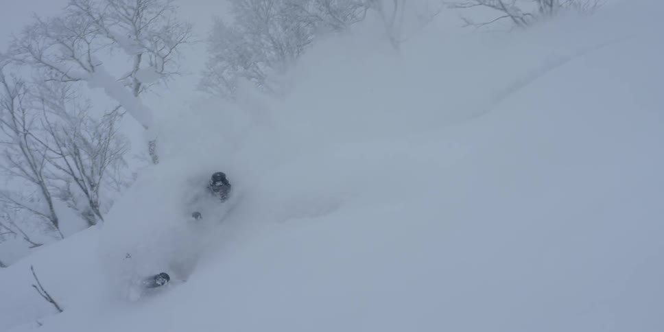 Skier riding down a snow covered hill