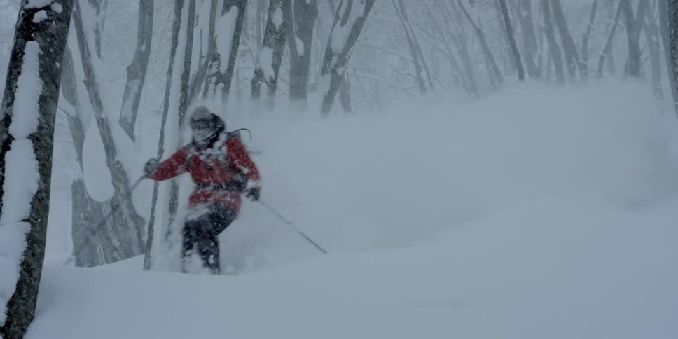 A person skiing down a snowy slope