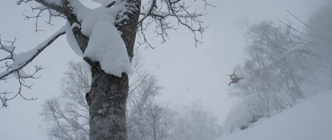 A person doing a big jump on skis and falling