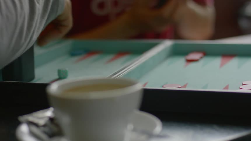 Two people are playing backgammon in the restaurant