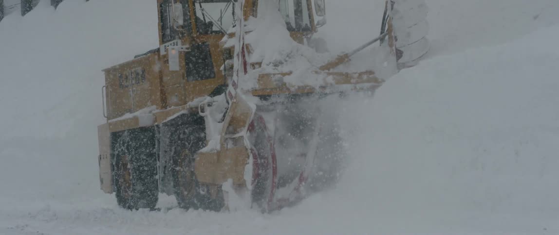 A piece of heavy machinery working in the snow