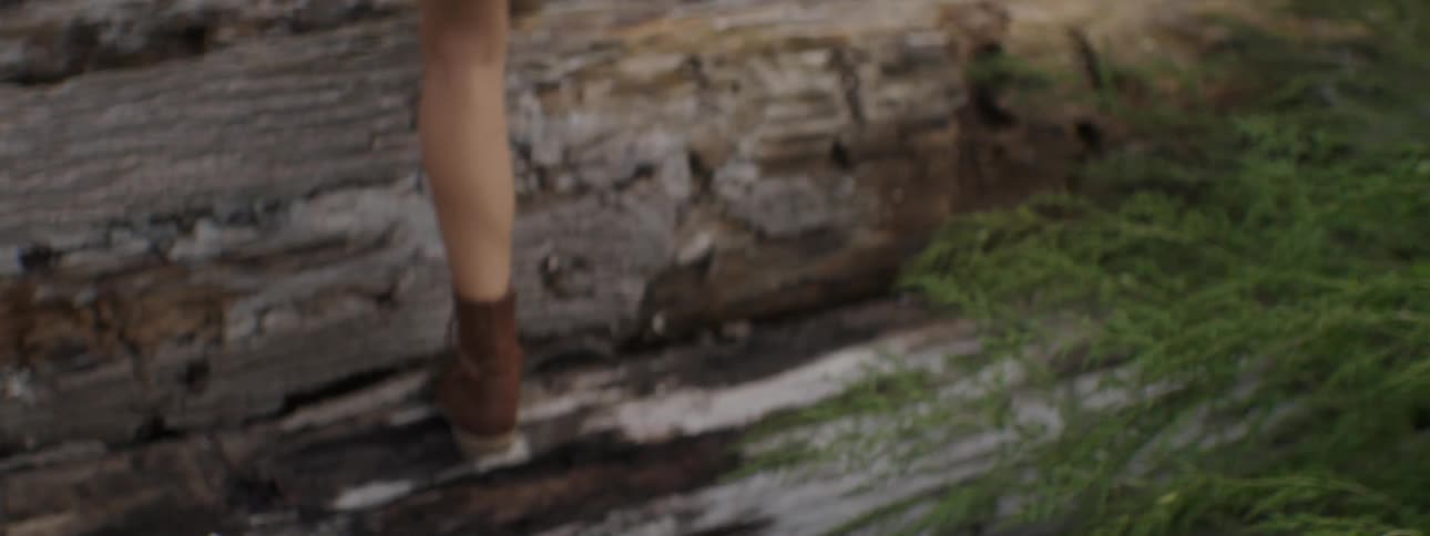 A woman jumping on logs