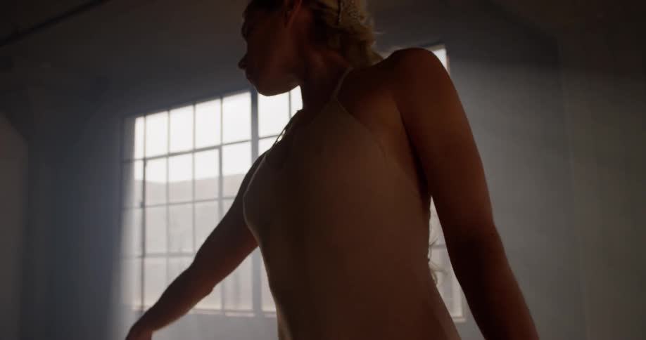 A woman stretches and dances