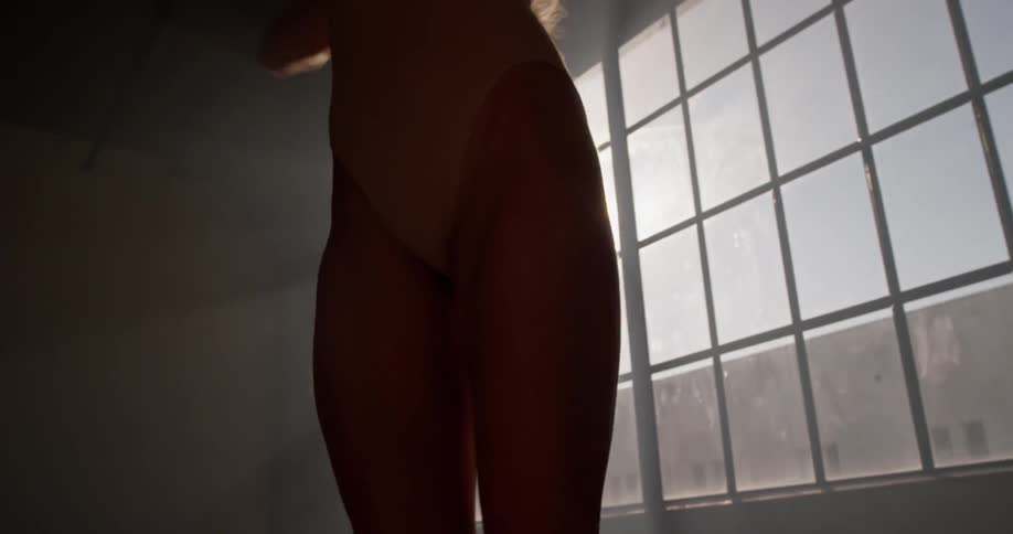 Teenage ballet dancers twirls in dark room