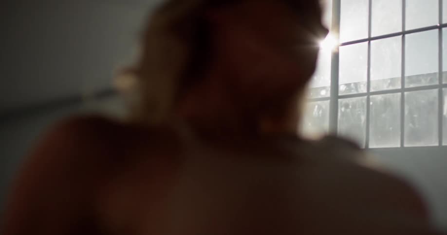 A woman stretching with a window in the background