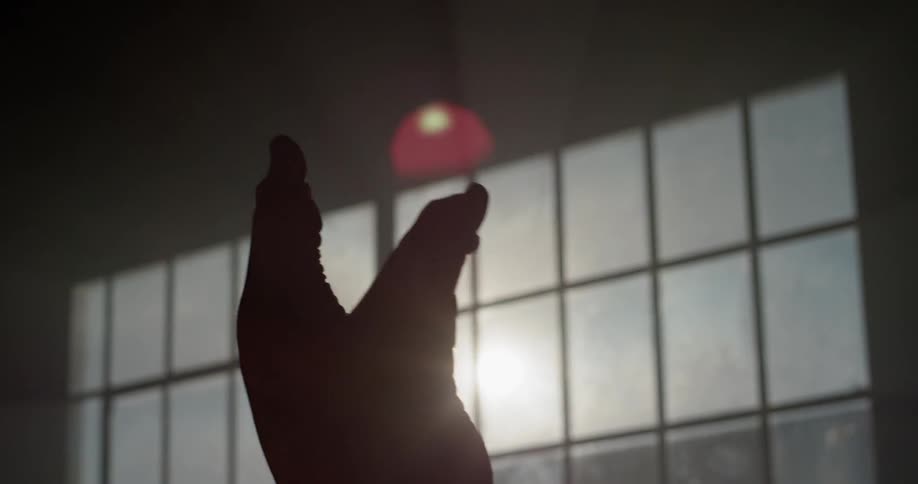 A womans feet in the air doing poses and stretching