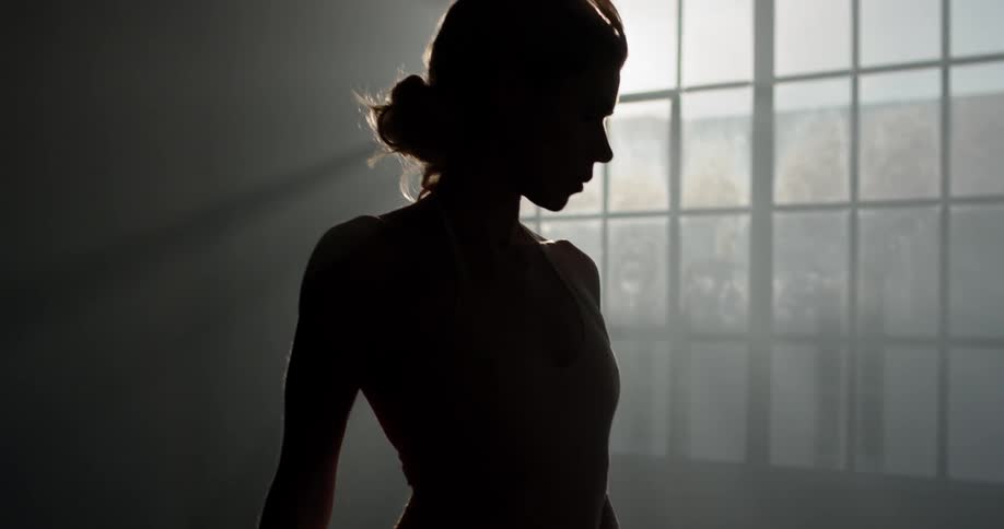 A young dancer poses in a studio