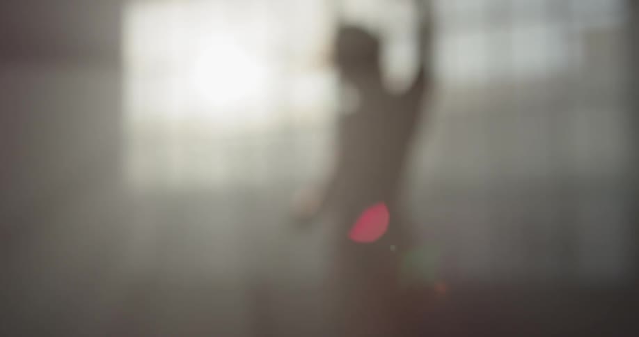 A woman jumps and spins as she dances by herself