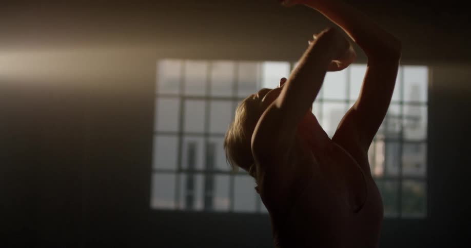 A woman in a dance studio dancing