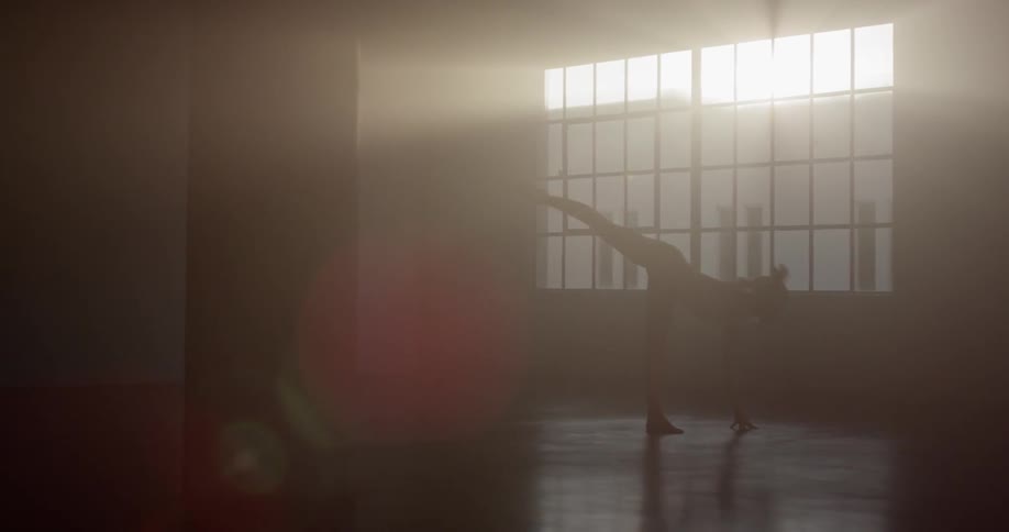 A woman stretches her leg high in the air and then leans over to the floor in dance poses