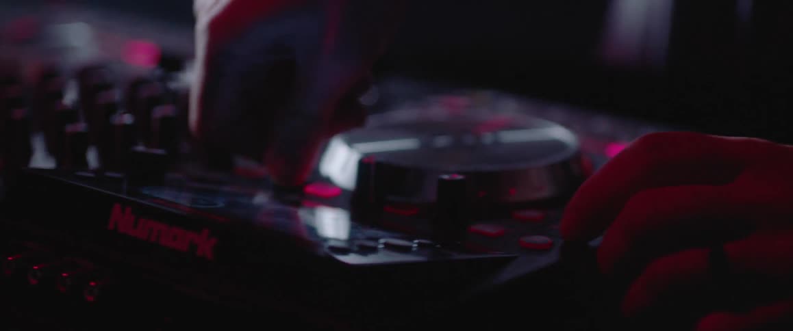 Someone adjusts knobs on a machine