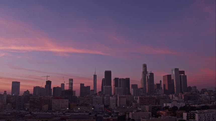 Skyscrapers in a city skyline at sunset