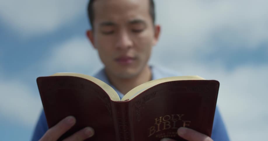 A young man reads the bible