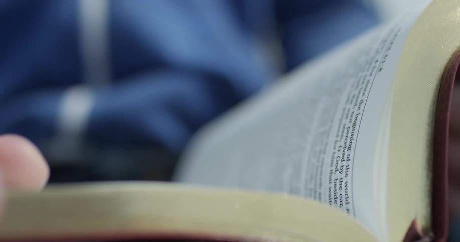 A person turns pages in a book