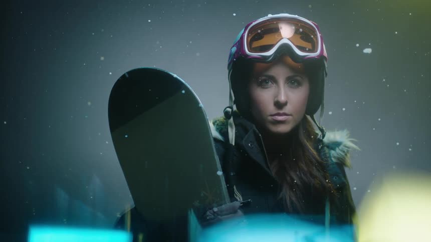 A woman ready to go snowboarding
