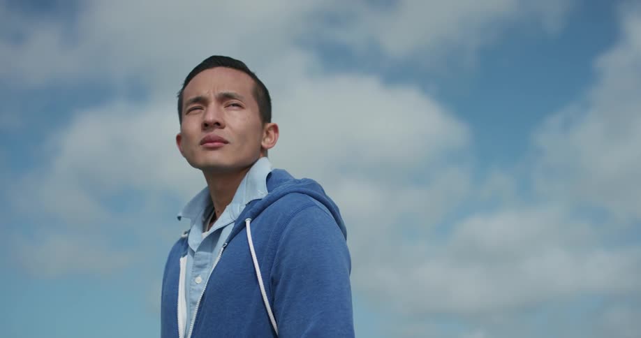 A man standing outdoors looking around