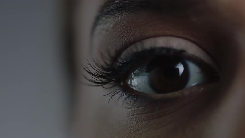 A woman with brown eyes blinking