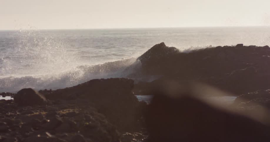 Waves crash into a rocky coastline