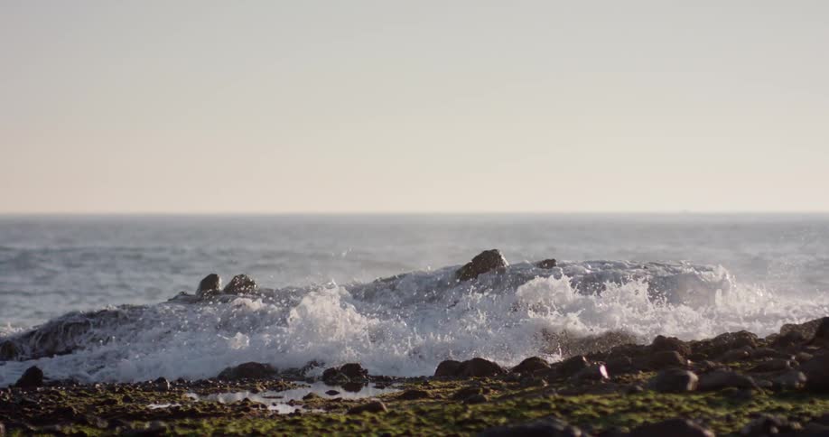 Ocean waves crash violently onto the shore