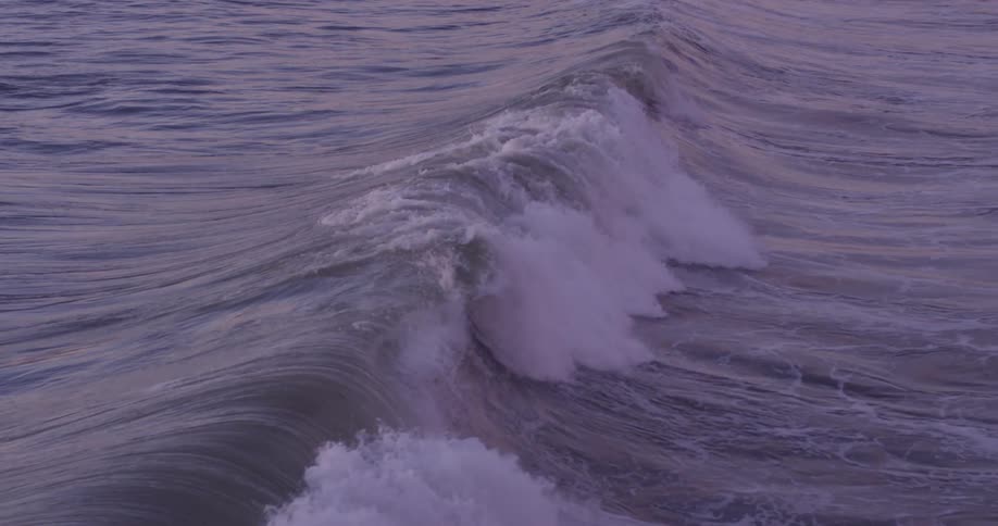 Waves rise and fall in the sea