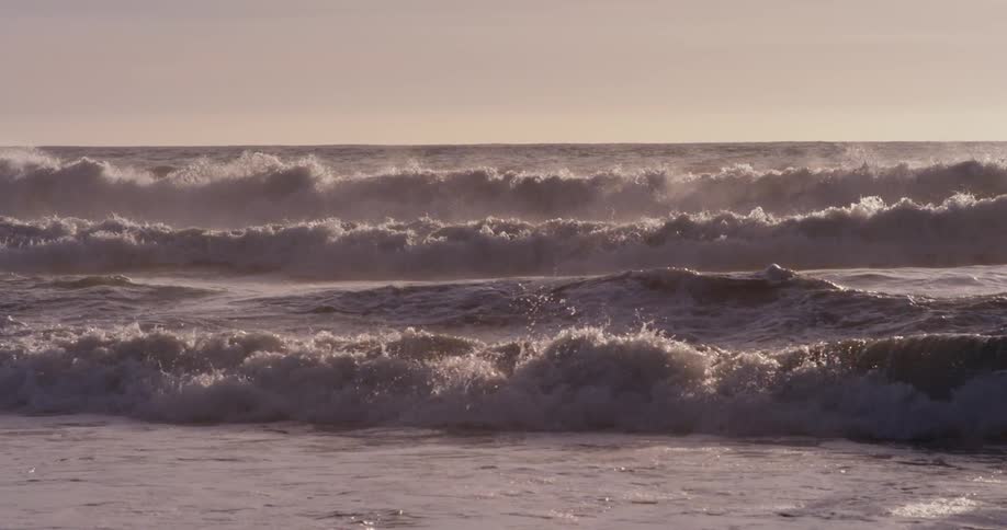 As he bobs up and down in the ocean the surfer is no match for the oceans powerful waves