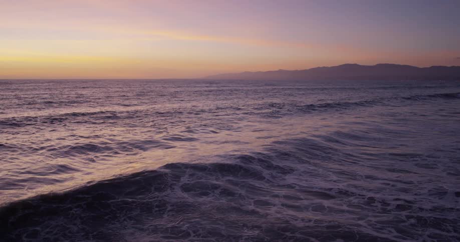 Waves roll over the surface of the ocean