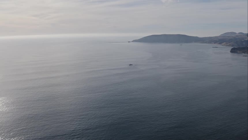 A scenic view from above overlooking a coastal bay near the ocean