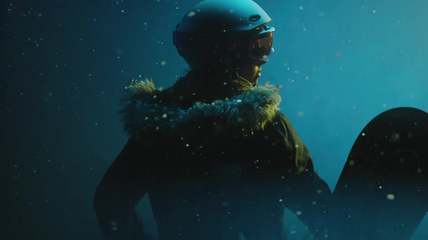 Snow falling on a woman wearing a helmet and goggles