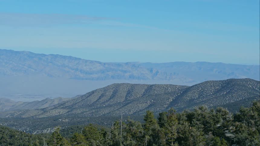 Green mountainous area with trees and hills and valleys