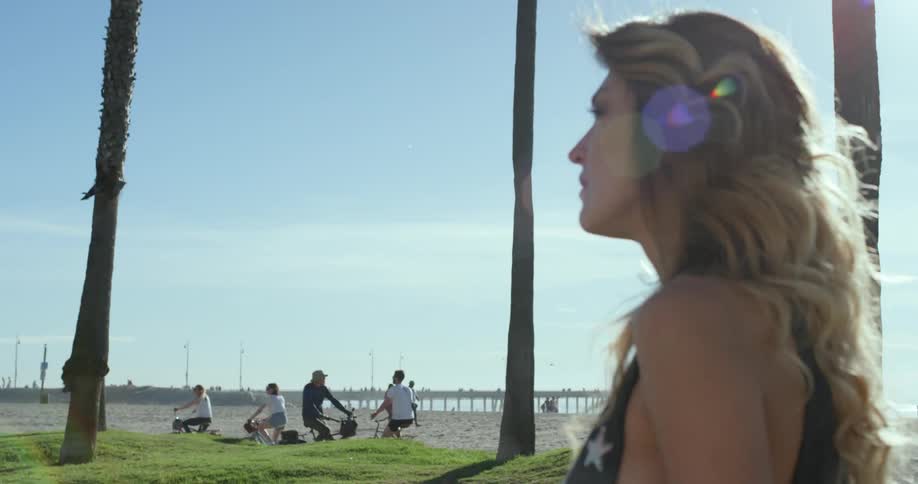 A young girl walks along the beach
