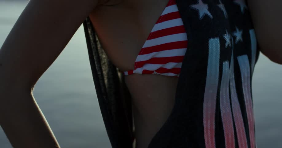 A woman is standing outside by a beach