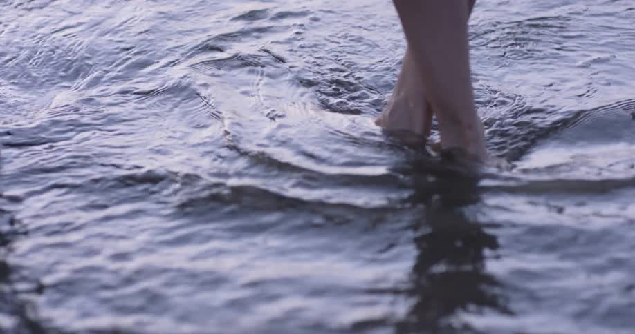 A person stands in flowing water