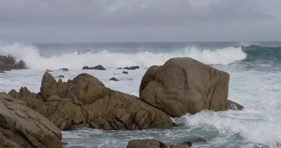 Huge waves smash on large coastal rocks