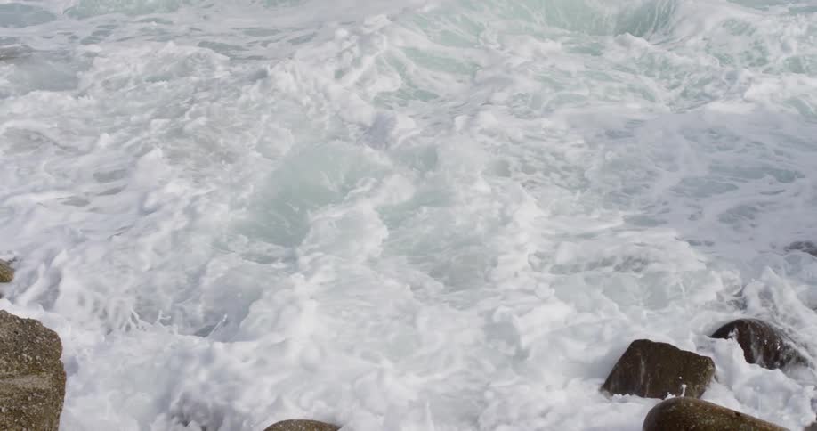 Ocean crashing into the rocks and rolling back