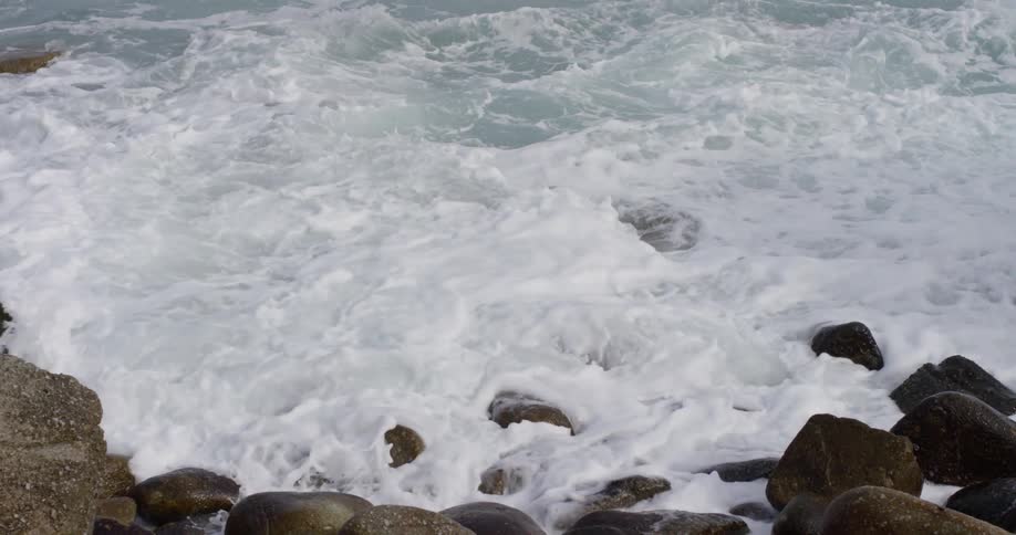 Waves catch in to a bed of rocks