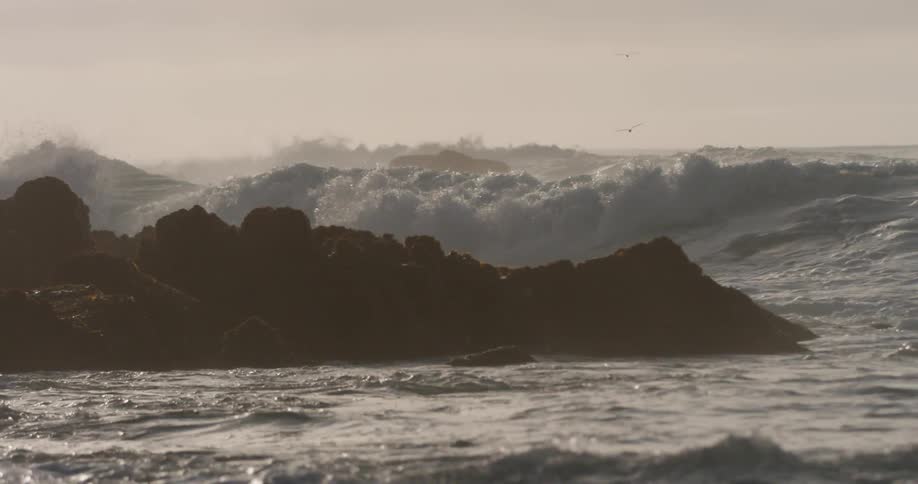Huge waves crash into a rocky coast line