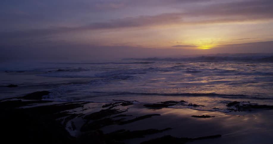 Waves crash along a beach